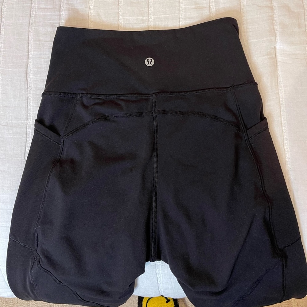 Lululemon 28” black leggings with mesh along bottom and sides of legs
